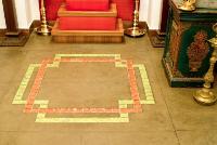 glass tile inlay in Kolam pattern on the tiled floor.